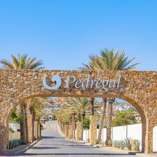 The distinctive stone entrance arch marks your arrival at this Mediterranean resort destination.