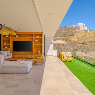 Relax in your stunning open-plan living space where floor-to-ceiling windows frame breathtaking mountain views and seamlessly connect indoor comfort with outdoor tranquility.