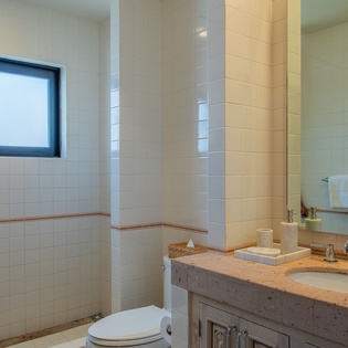 Step into your elegant bathroom with gleaming tiles, granite counters, and a spacious walk-in shower perfect for unwinding after adventures.