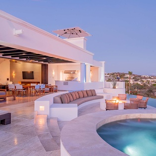 A stunning hillside retreat overlooking the Mediterranean coastline, perfect for unwinding under the stars as the sun sets over the sea.