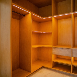 Unpack in style with this spacious walk-in closet featuring warm LED lighting and custom shelving for all your belongings.