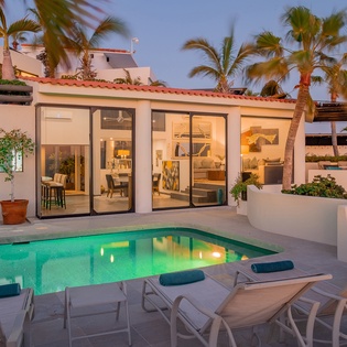Poolside view of exterior during sunset