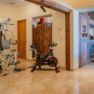 Your private home gym awaits with professional equipment and rustic charm for energizing workouts.