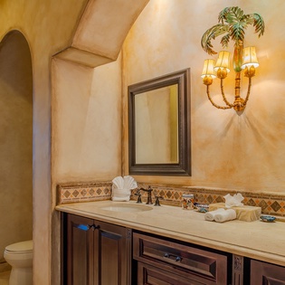 Indulge in your luxurious ensuite bathroom featuring elegant marble countertops, tropical palm lighting, and a spacious walk-in shower.