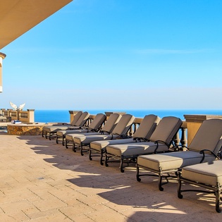 Ocean view patio with lounge chairs