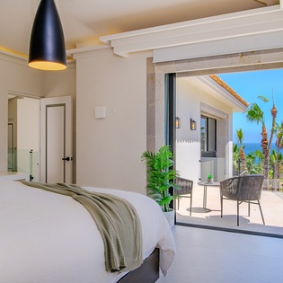Bedroom suite with terrace access and ocean view