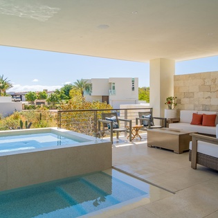 Unwind on your private terrace with dual pools and stylish seating, where modern comfort meets tropical tranquility.