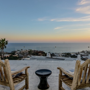 Spectacular ocean views stretch across the horizon from your private terrace, where comfortable seating awaits for unforgettable sunset moments.