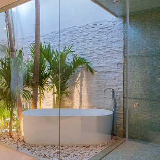 Tropical en suite bathroom with bathtub and walk in shower