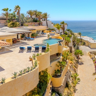 Stunning beachfront villa with infinity pool, tropical gardens, and panoramic ocean views in an exclusive coastal setting.
