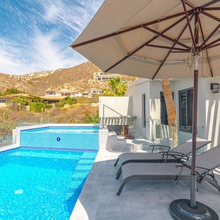 Unwind poolside on your private terrace with comfortable loungers and mountain vistas stretching beyond the sparkling blue waters.