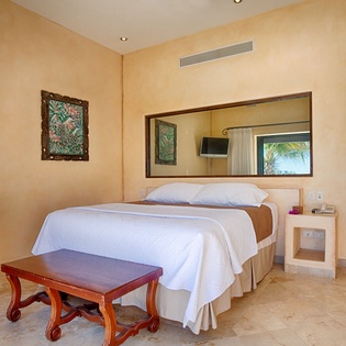 Drift off in your serene bedroom with ocean views, crisp linens, and elegant tropical decor welcoming you to your personal oasis.