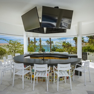 Outdoor bar seating with Tv entertainment
