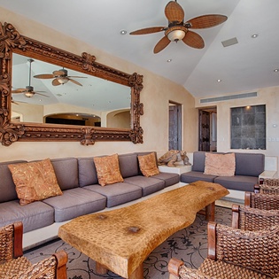 Sink into the plush sectional and unwind in your spacious living room, where tropical-style furnishings and elegant details create a welcoming retreat for relaxation.