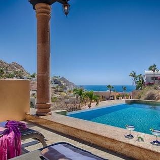 Relax poolside as you take in stunning ocean views that stretch to the horizon, framed by swaying palms and hillside charm.