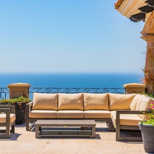Relax on your private terrace with plush seating and breathtaking ocean views stretching to the horizon.