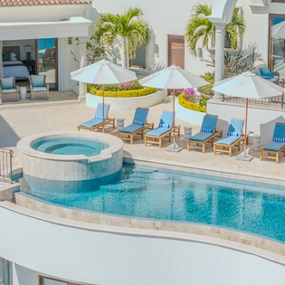 You'll love lounging by this stunning infinity pool, complete with hot tub and premium sunbeds under white umbrellas.