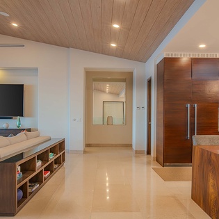 Step into this modern open-concept living space where warm wood tones meet sleek design. Natural light flows through, highlighting the vaulted ceiling and inviting you to relax in comfort.