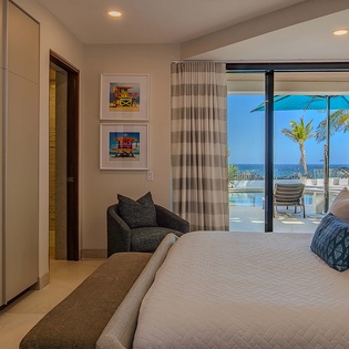 Drift off in your serene bedroom where plush bedding meets ocean views. Step onto your private terrace to soak in the coastal breeze and endless blue horizons.