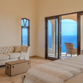 Bedroom suite with private balcony and ocean views