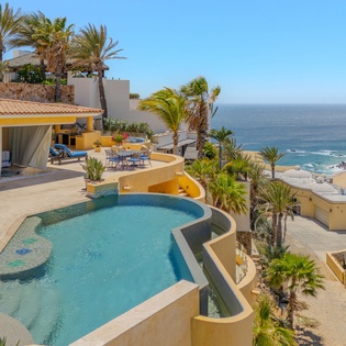 Stunning beachfront villa with infinity pool overlooking pristine coastline and tropical gardens.
