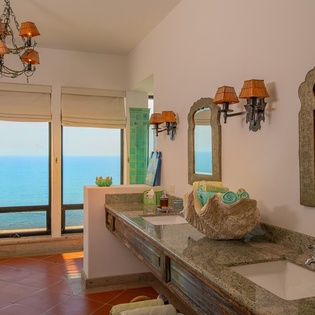 En suite bathroom with double sink and walk in shower
