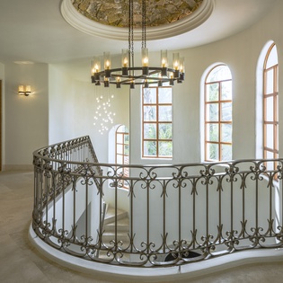 Step into elegance with soaring ceilings, ornate ironwork, and grand windows that fill your private retreat with natural light.