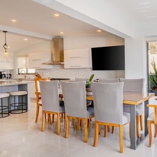 Your open-plan kitchen flows into a bright dining area where memorable meals await around the elegant table for eight.