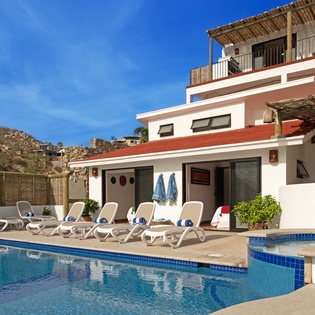 Modern villa with private pool and mountain backdrop in a peaceful desert setting.