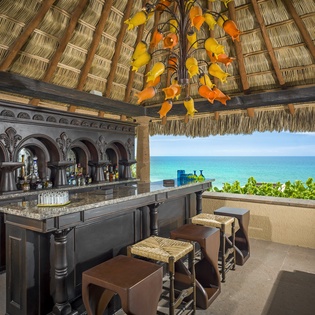 Sip your favorite drink at this stunning oceanfront bar with handcrafted details and breathtaking sea views.