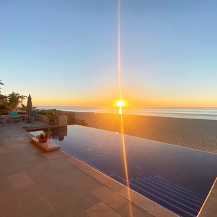 Poolside patio with beachfront views during sunrise