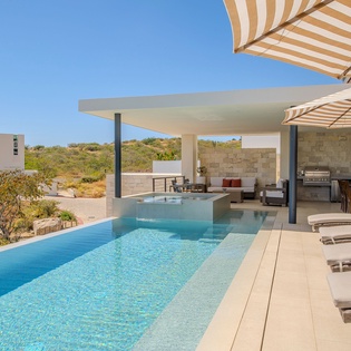 Dive into crystal-clear waters while lounging on your private terrace, where modern comfort meets stunning natural landscape views.