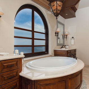 En suite bathroom with bathtub and ocean views