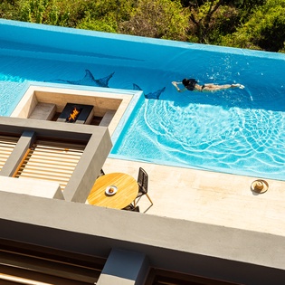 Sunny patio with infinity pool and ocean view