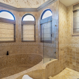 En suite bathroom with bath tub and walk in shower
