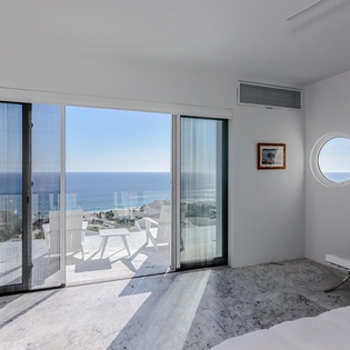 Wake up to breathtaking ocean views from your luxurious bedroom, where floor-to-ceiling windows frame the endless sea horizon perfectly.