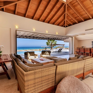 Spacious open living area with patio access and ocean views