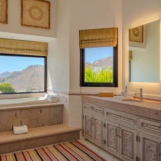 Soak in your private mountain-view tub while desert peaks frame your relaxing retreat through picture windows.