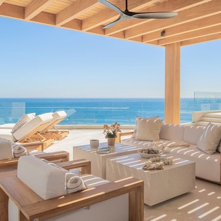 Sunny patio with wrapping ocean views and patio seating