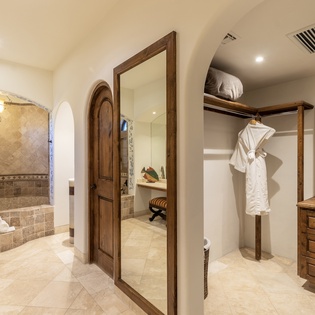En suite bathroom with bathtub and walk in closet