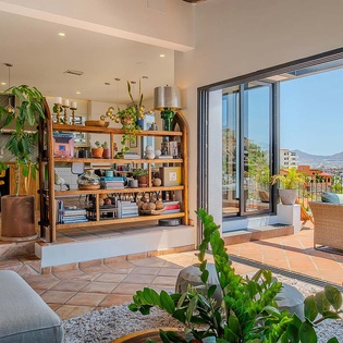 Step into a sun-drenched living space where modern comfort meets natural beauty. Enjoy your morning coffee surrounded by lush greenery, with sweeping mountain and city views from your private terrace.