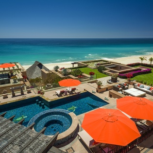 Stunning beachfront villa featuring pool, spa, and pristine beach access with vibrant tropical gardens and ocean views.