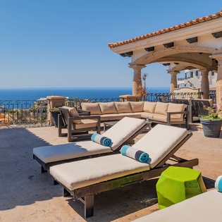 Unwind on your private terrace with plush loungers and panoramic ocean views, where luxury meets endless blue horizons.