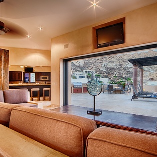 Step inside your open-concept retreat where warm desert tones meet modern comfort. Sink into plush seating, enjoy entertainment on the flat-screen TV, and seamlessly flow outdoors to your private patio with pool and mountain views.