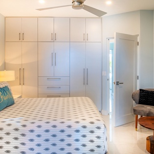 Relax in your serene bedroom with crisp linens, ample storage, and modern comfort including air conditioning and ceiling fan.