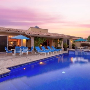 Poolside view of villa during sunset