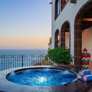 Soak in your private hot tub as the sun sets over the sea, with arched terraces framing breathtaking ocean views and cool evening breezes.