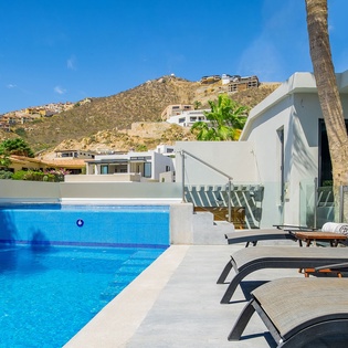 Dive into crystal-clear waters while soaking up stunning mountain views from your private poolside retreat.