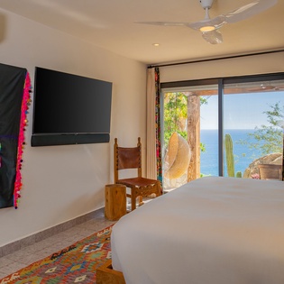 Wake up to stunning ocean views from your comfortable bedroom, where vibrant local art and modern amenities create your perfect coastal retreat.