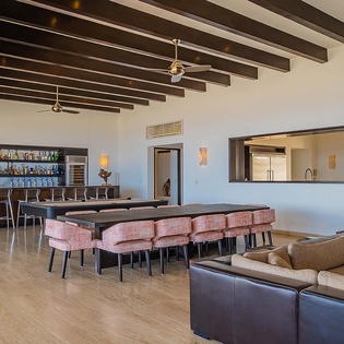 Gather around the sleek dining table or unwind at the fully-stocked bar beneath stunning wood-beam ceilings—your perfect setting for memorable meals and conversations.